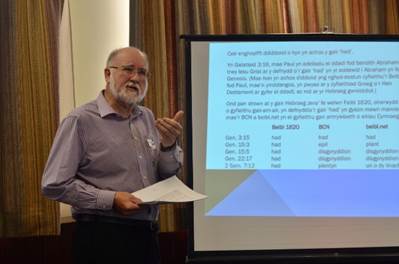 A person standing in front of a projector screen

Description automatically generated