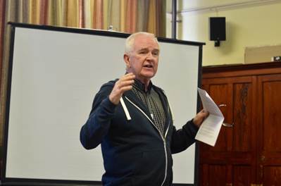 A person standing in front of a white board

Description automatically generated