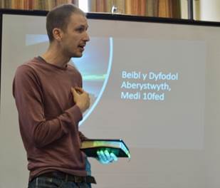 A person standing in front of a projection screen

Description automatically generated